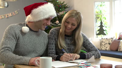 couple-writing-christmas-cards-together